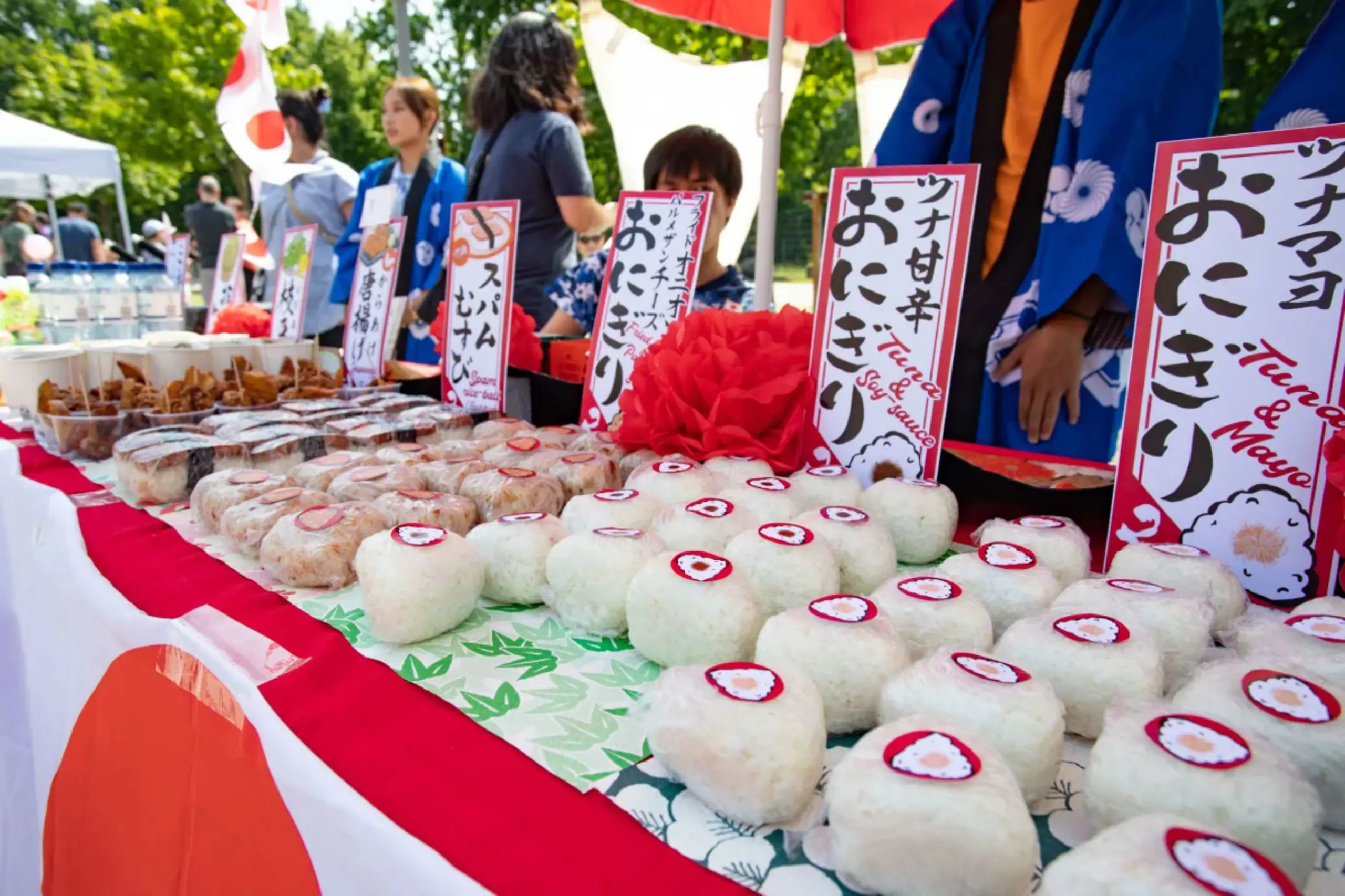 Close-up of freshly prepared Japanese rice balls arranged at an international food stall