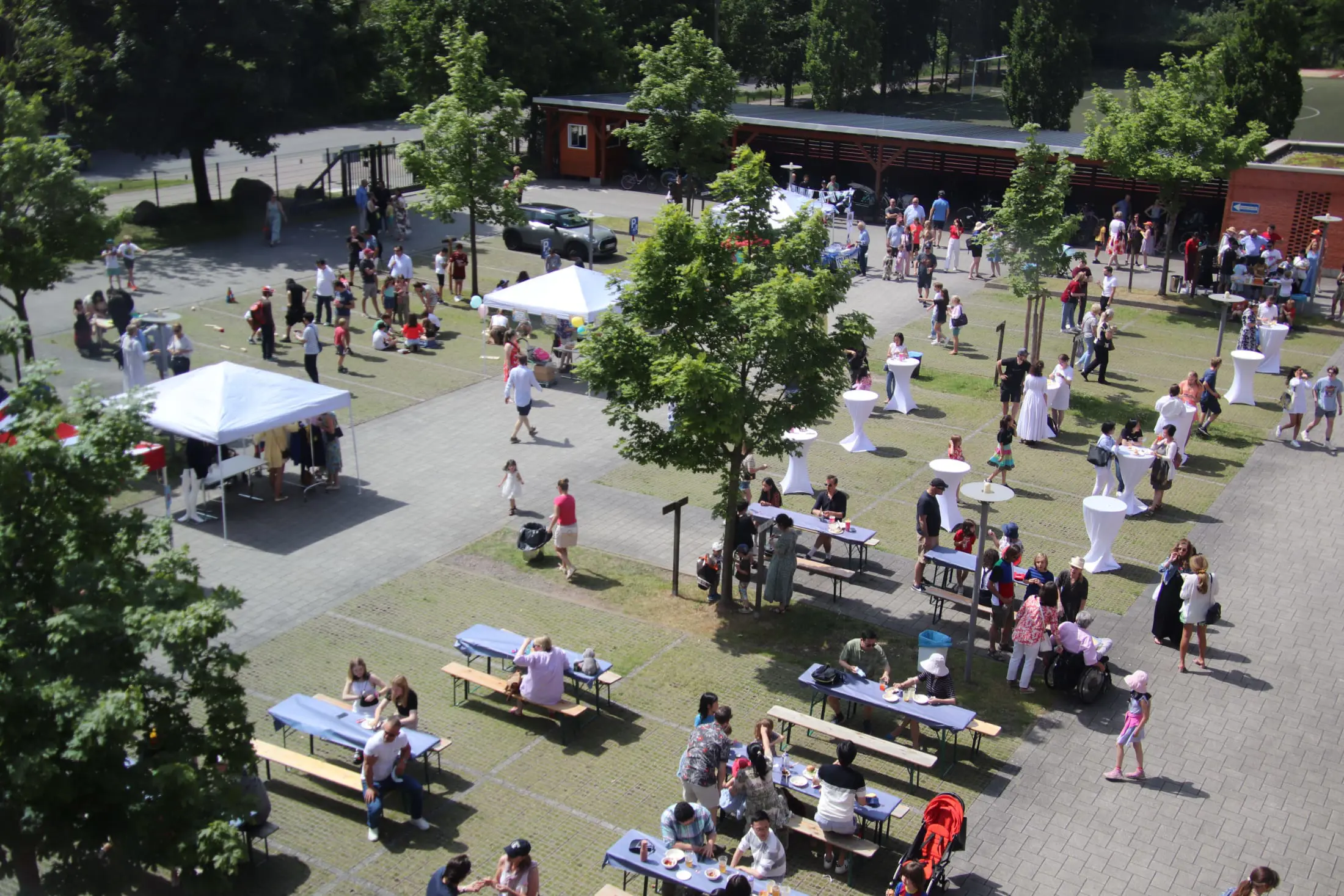 Aerial view of an outdoor community gathering at the International School of Hamburg campus courtyard