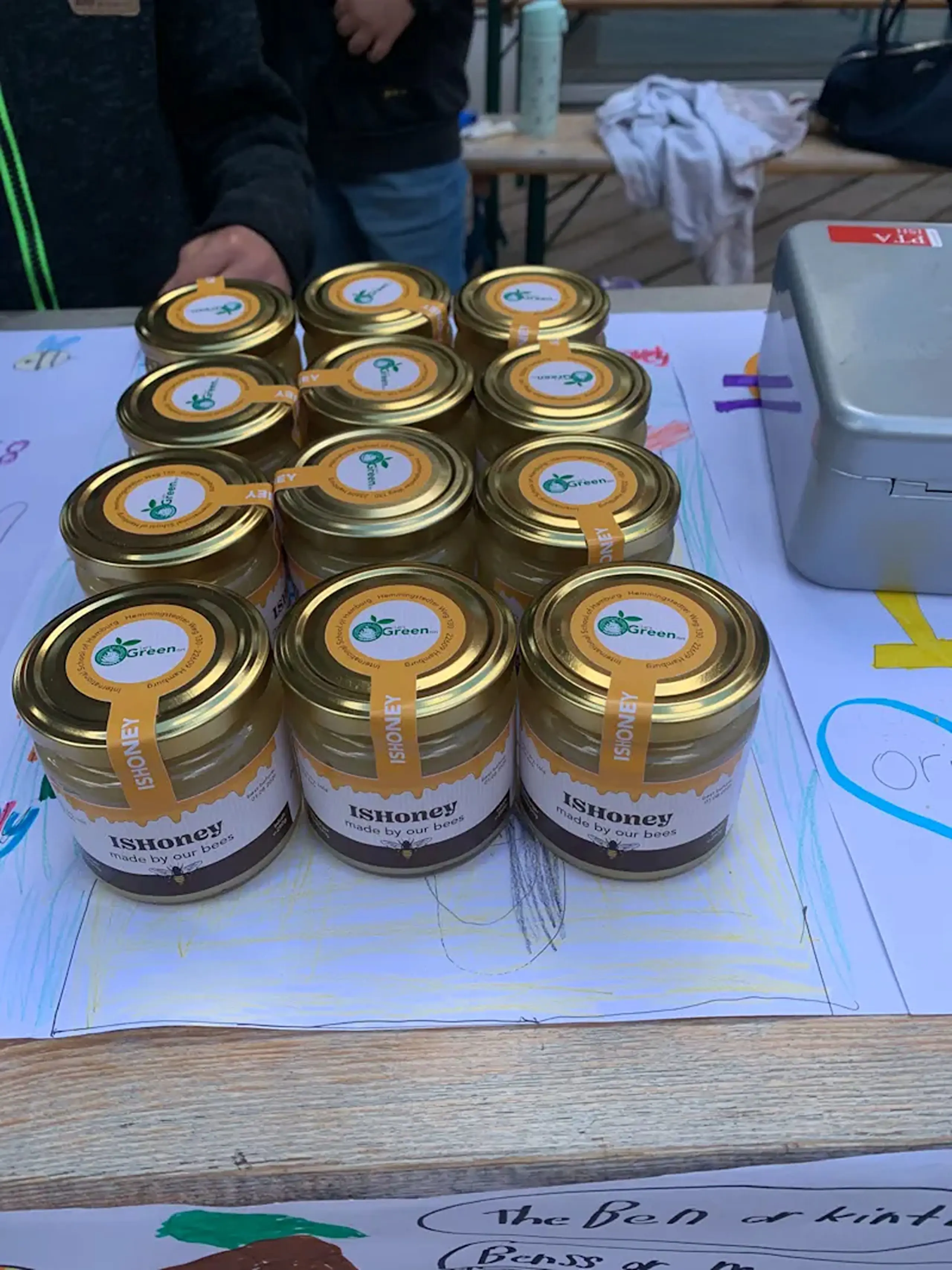 Small jars of student-harvested honey displayed on a table