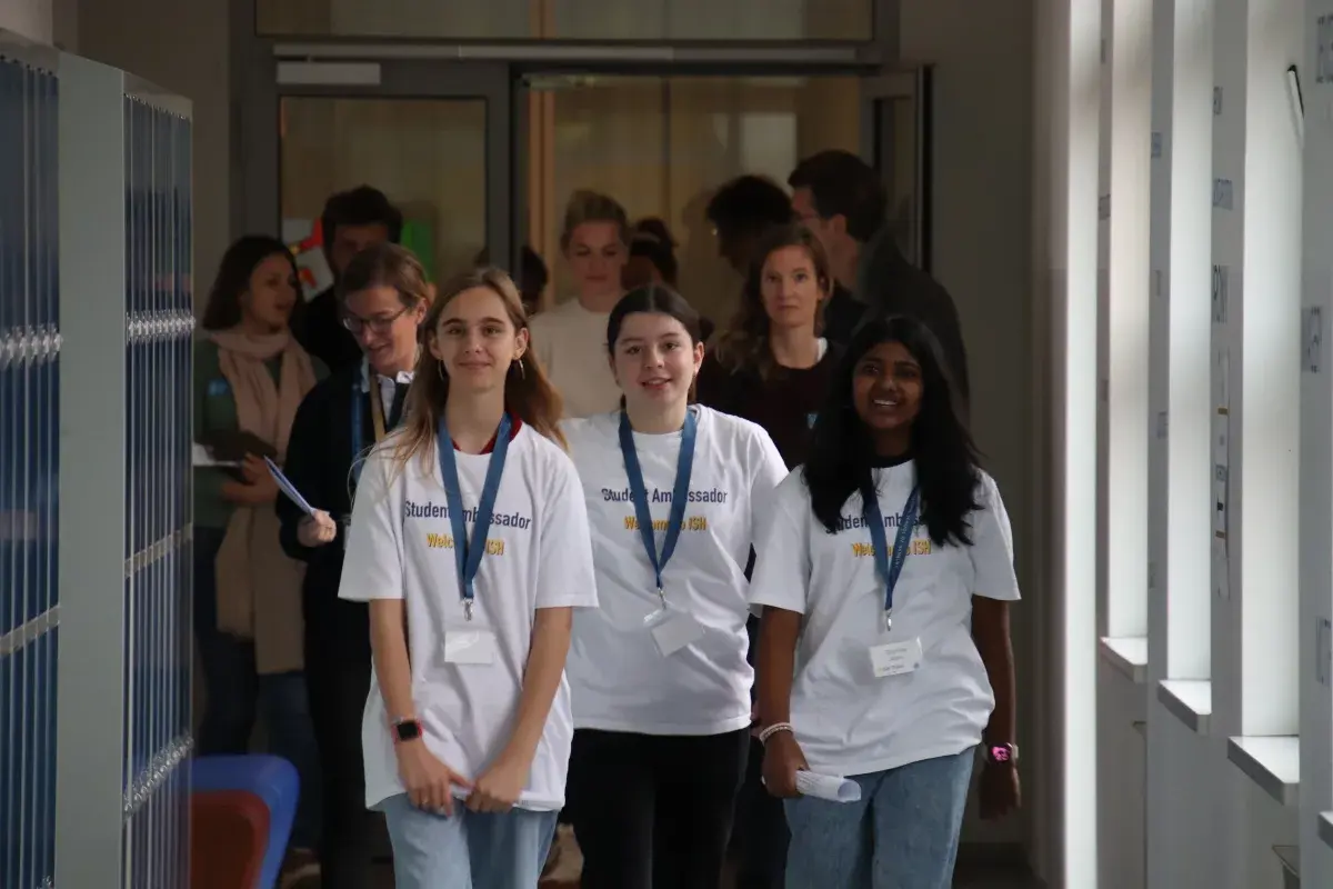 International School of Hamburg student ambassadors walking along the school hallway during an Open Day event