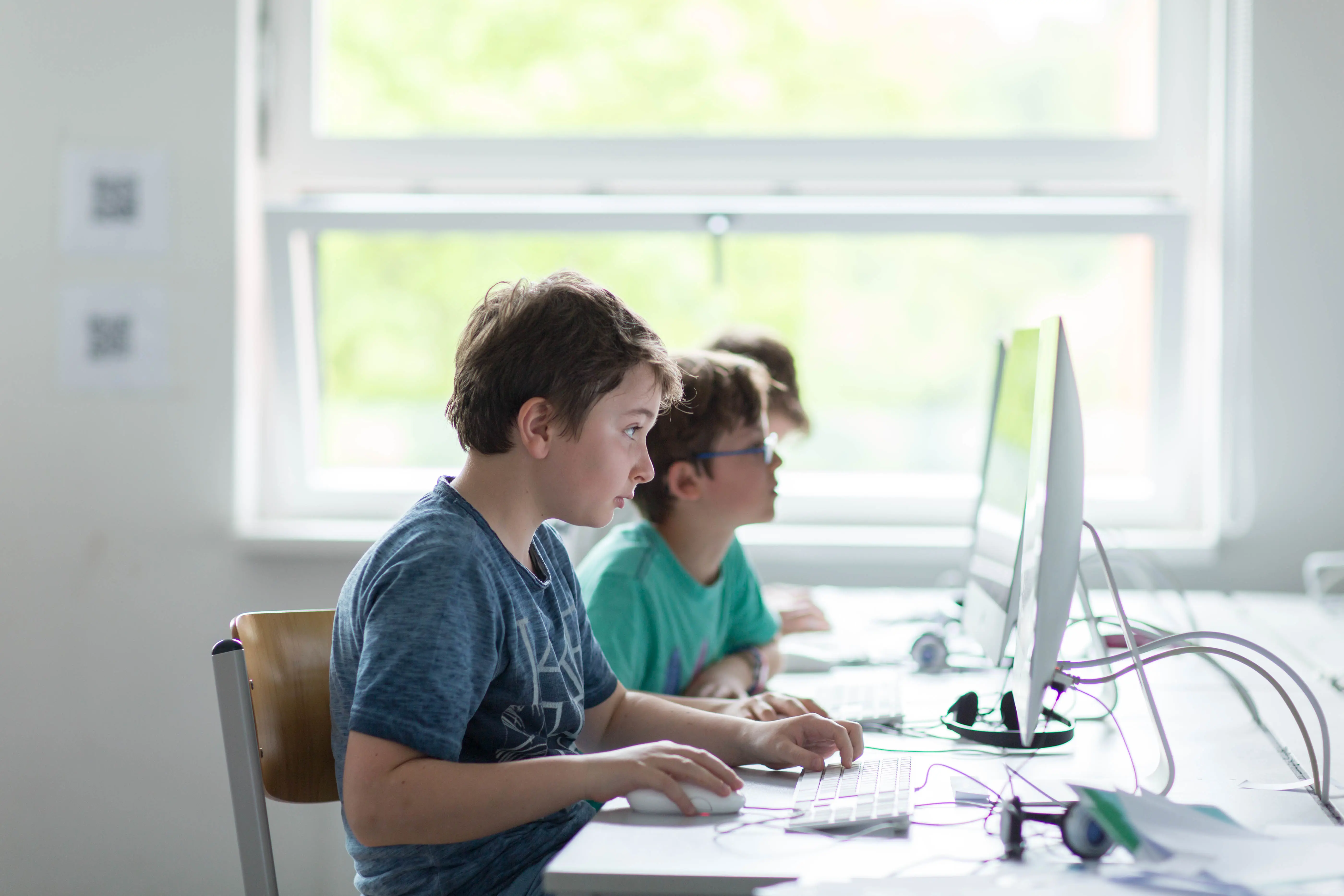 Two students working at desktop computers in an ISH technology-integrated classroom