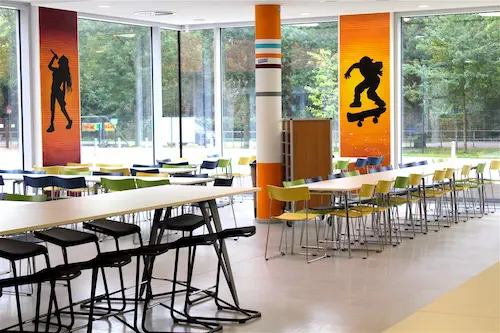 Spacious and sunlit cafeteria seating area at the International School of Hamburg
